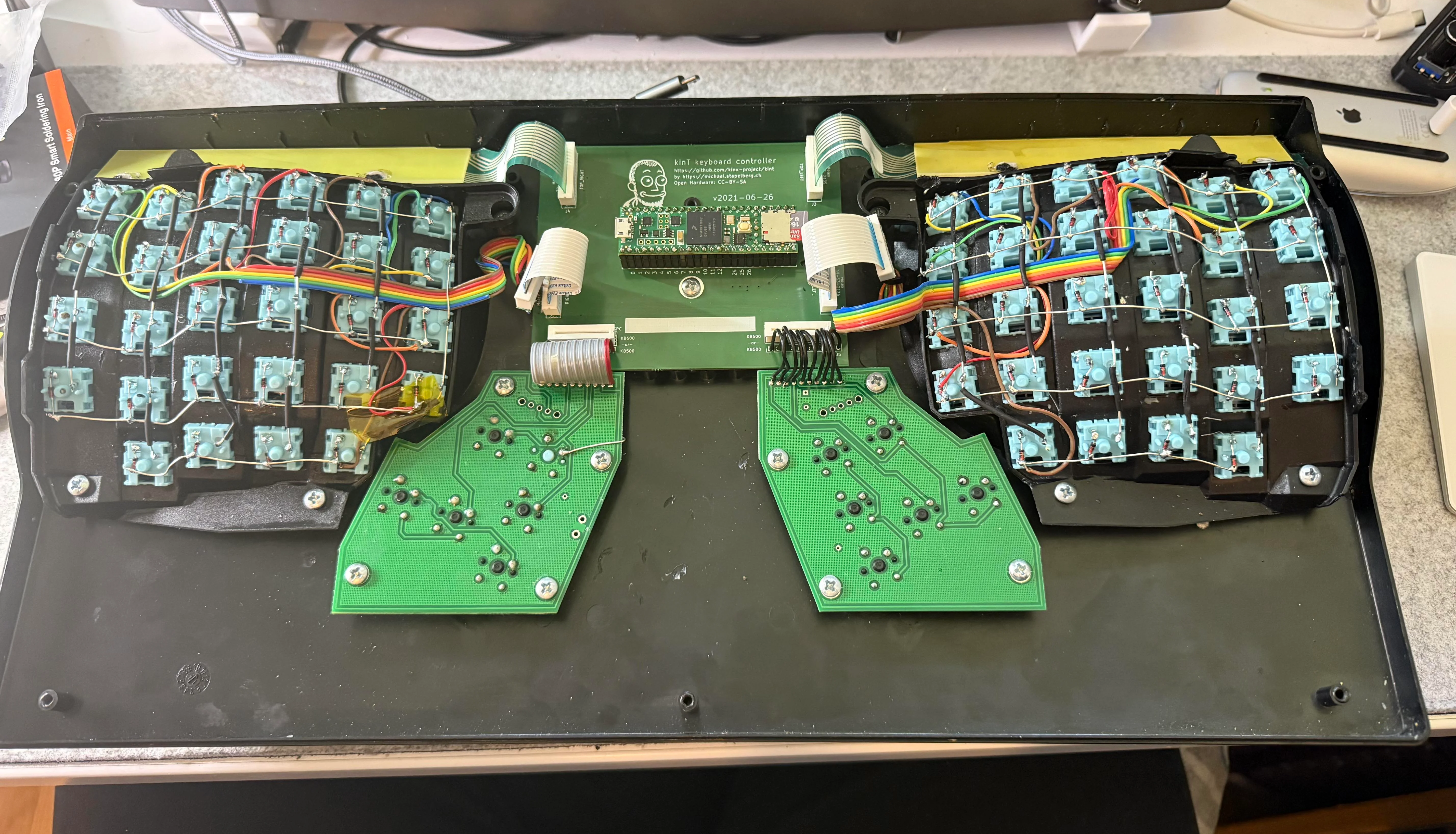 The inside of a Kinesis Advantage with new switches and a Stapelberg controller.