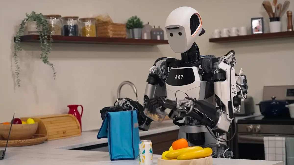 A humanoid robot packs a lunch bag in the kitchen