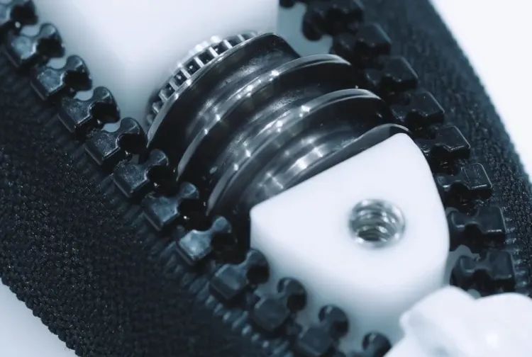 The self-propelled zip fastener uses a worm gear to propel itself along the teeth. (Credit: YKK)