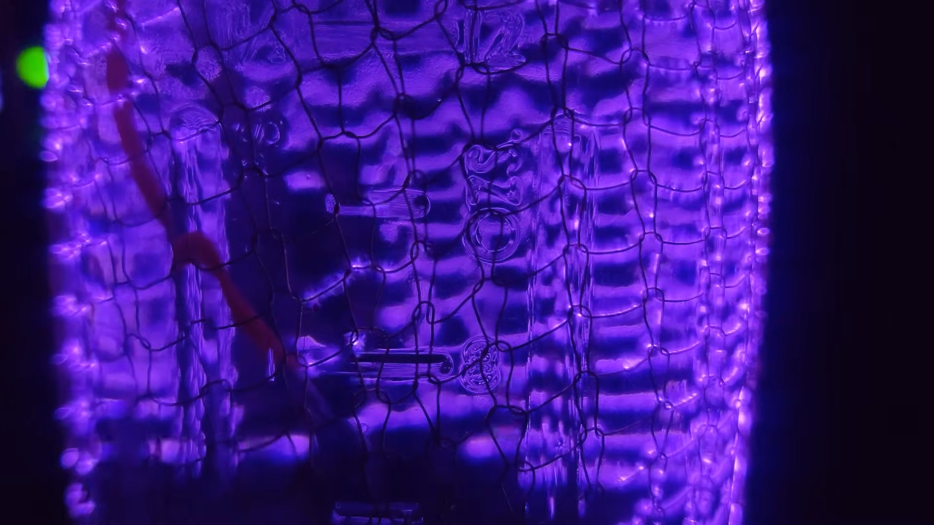 Grid overlayed onto a mason jar. Across the grid are high voltage purple coronas.