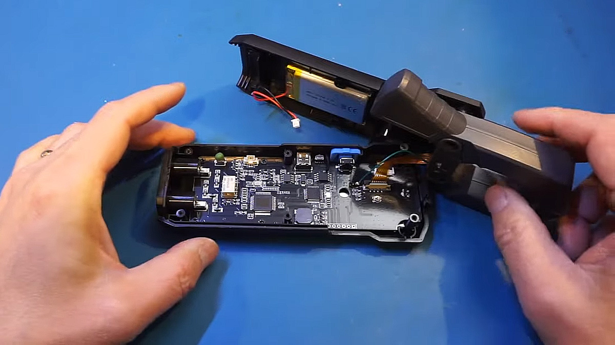 Pried open clamp meter on blue desk