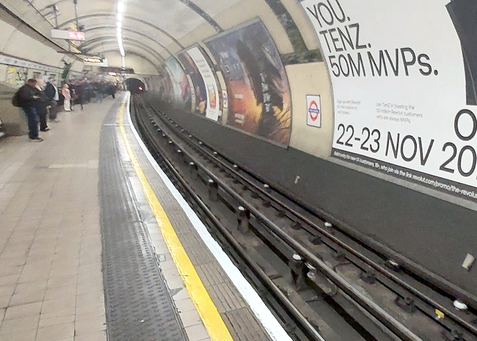 A Londom Underground deep tube station, looing doen the unoccupied platform.
