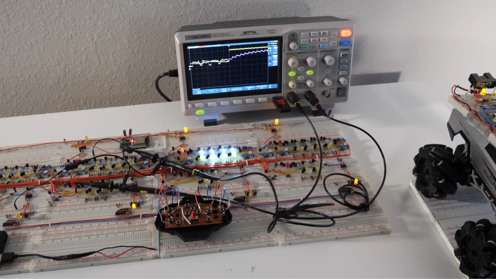 A photo of the circuitry along with an oscilloscope
