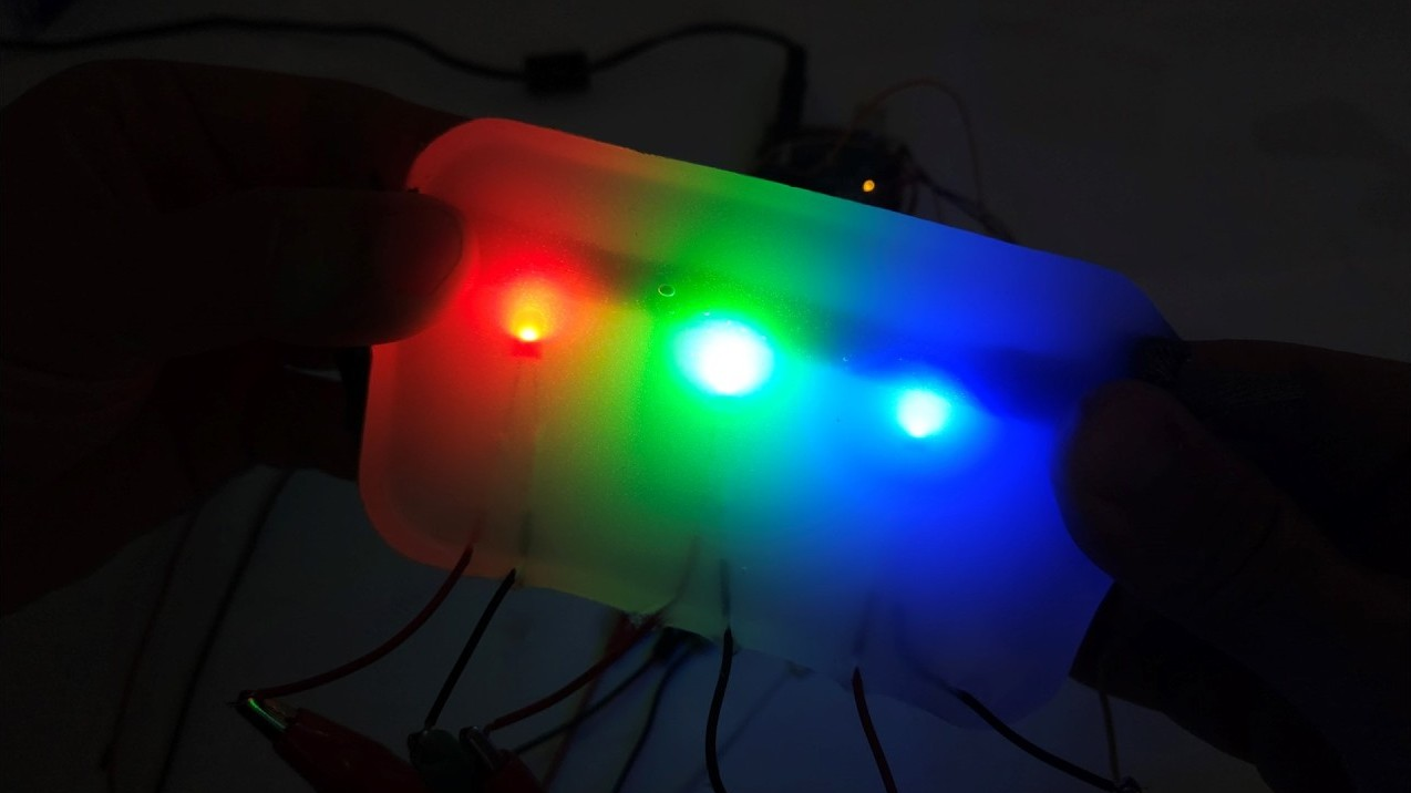Diffuse glow of red, green, and blue LEDs embedded in silicone