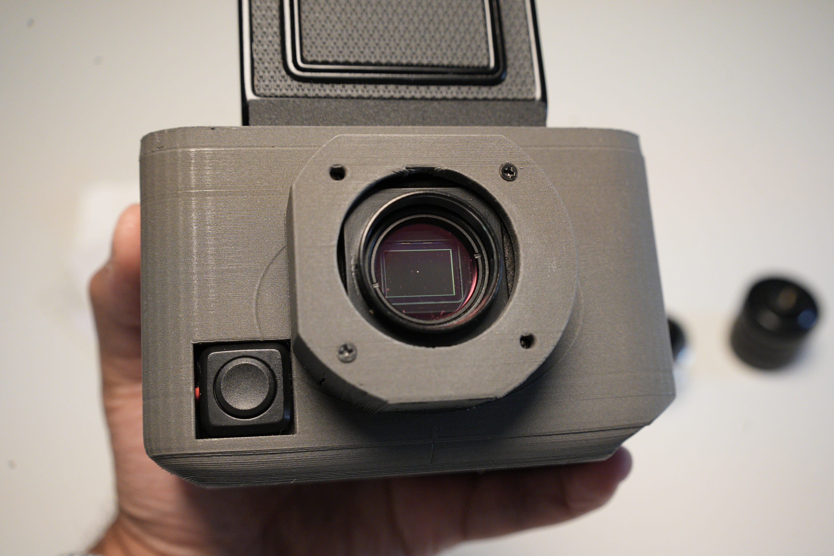 The camera, lens off to show the 1" sensor.