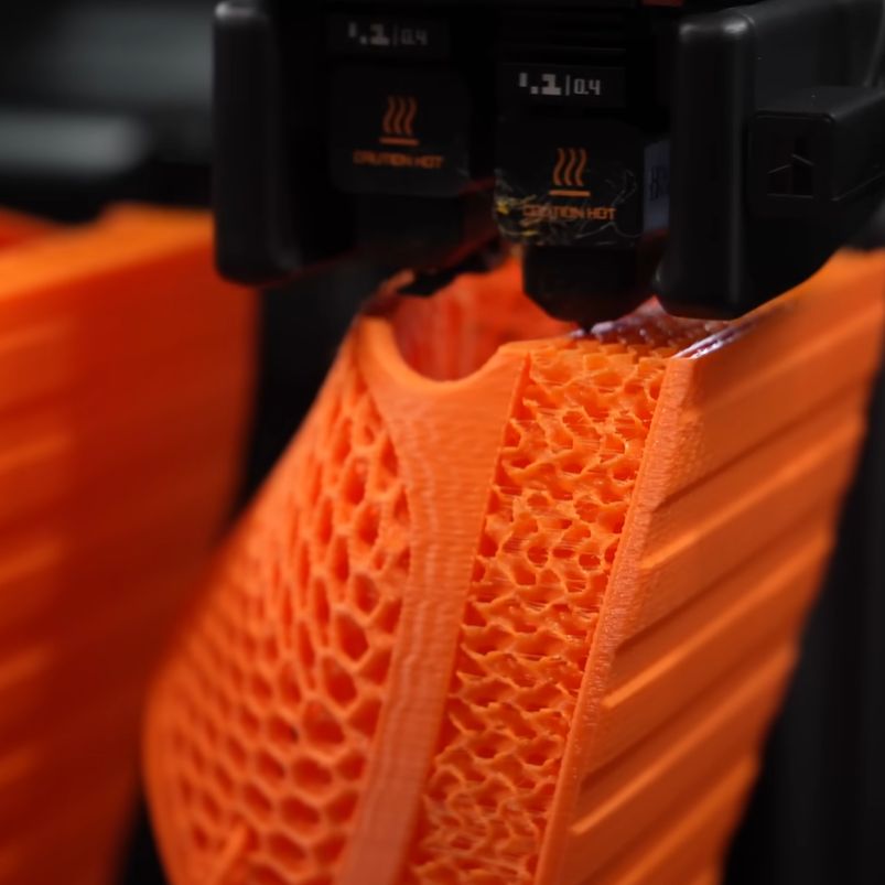 The BIQU MorPhlex TPU filament being turned into squishy slippers. (Credit: ModBot, YouTube)