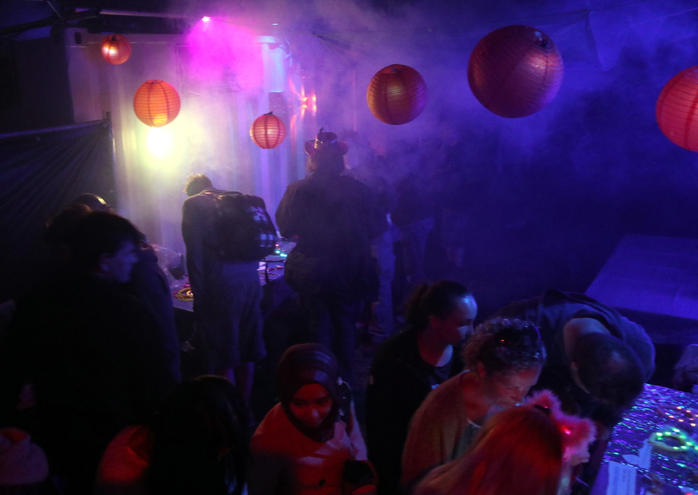 A nicht scene in a post-apocalyptic future, in this case an electronics bazaar adjacent to the rave area in EMF 2018 Null Sector.