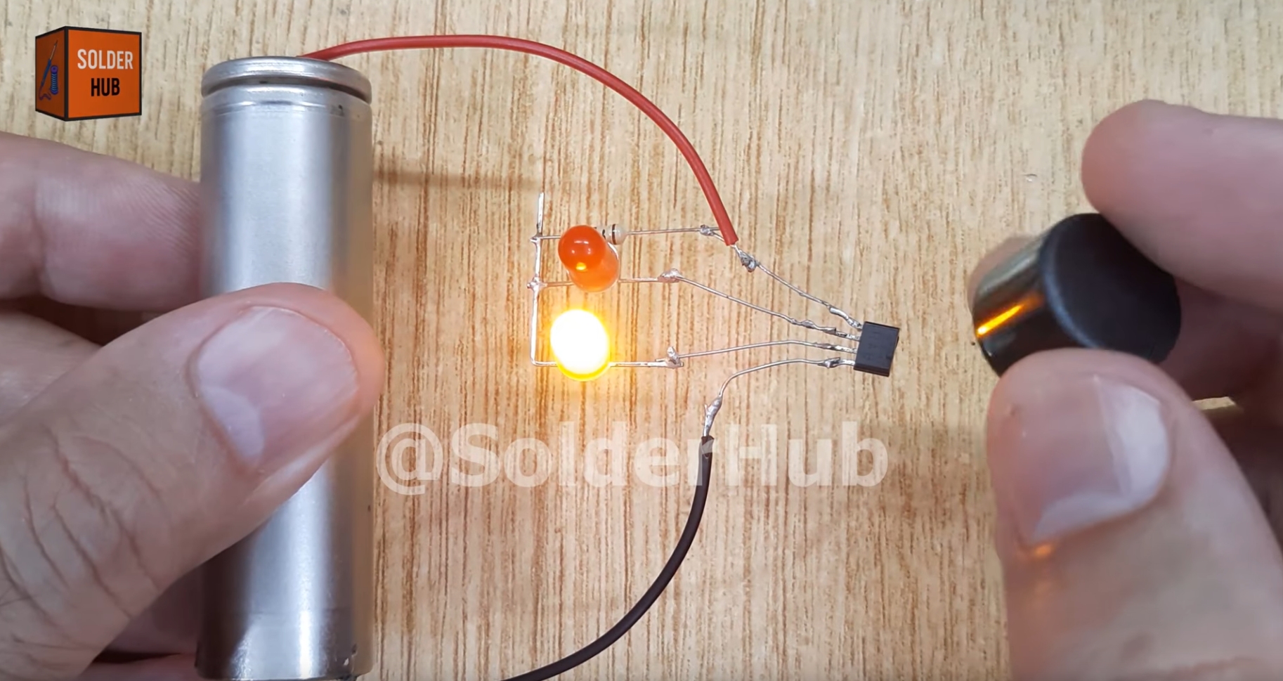 A photo of the air-wired circuit, with one LED on and the other off.