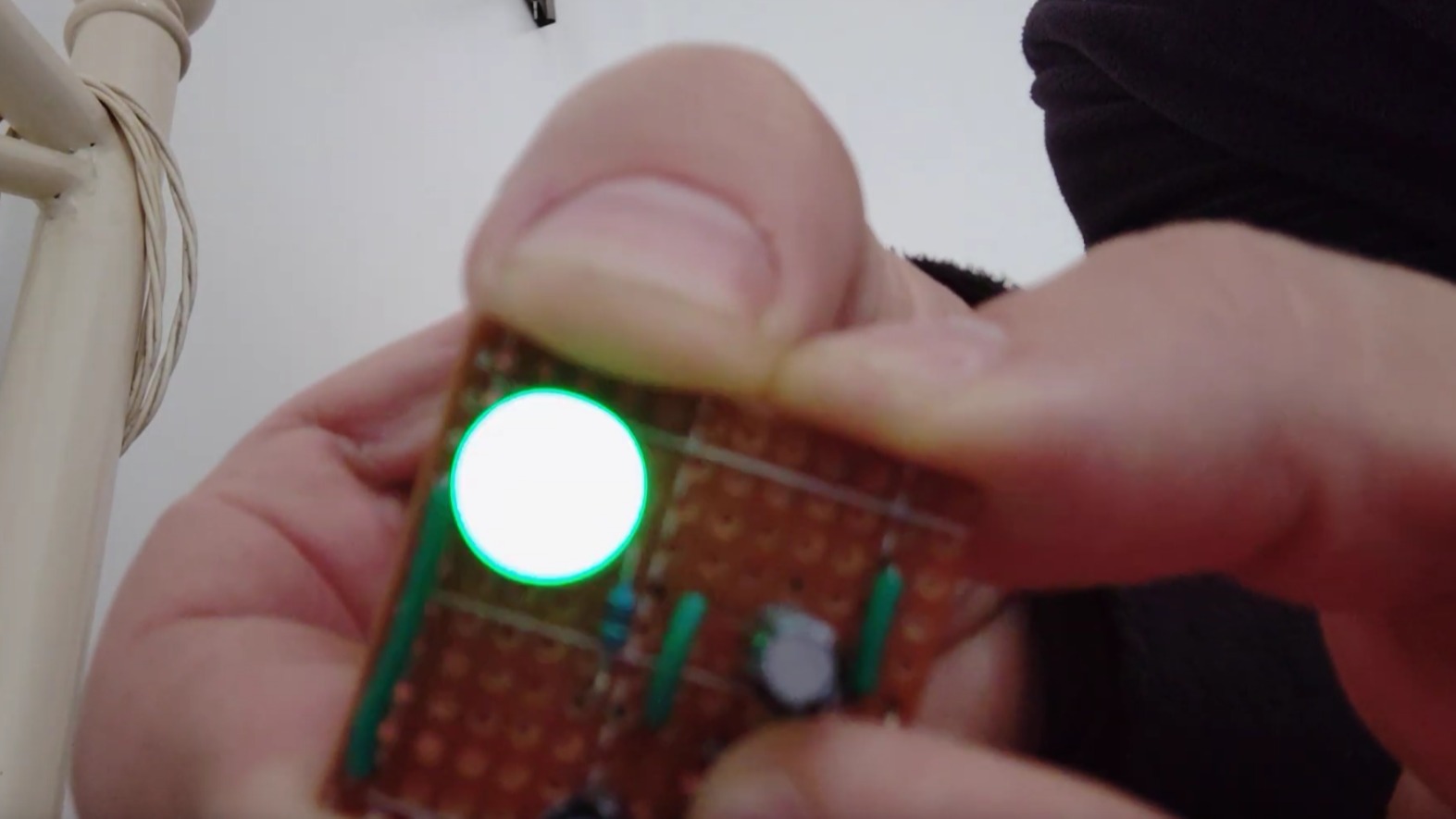 A hand holding the circuit in its active state