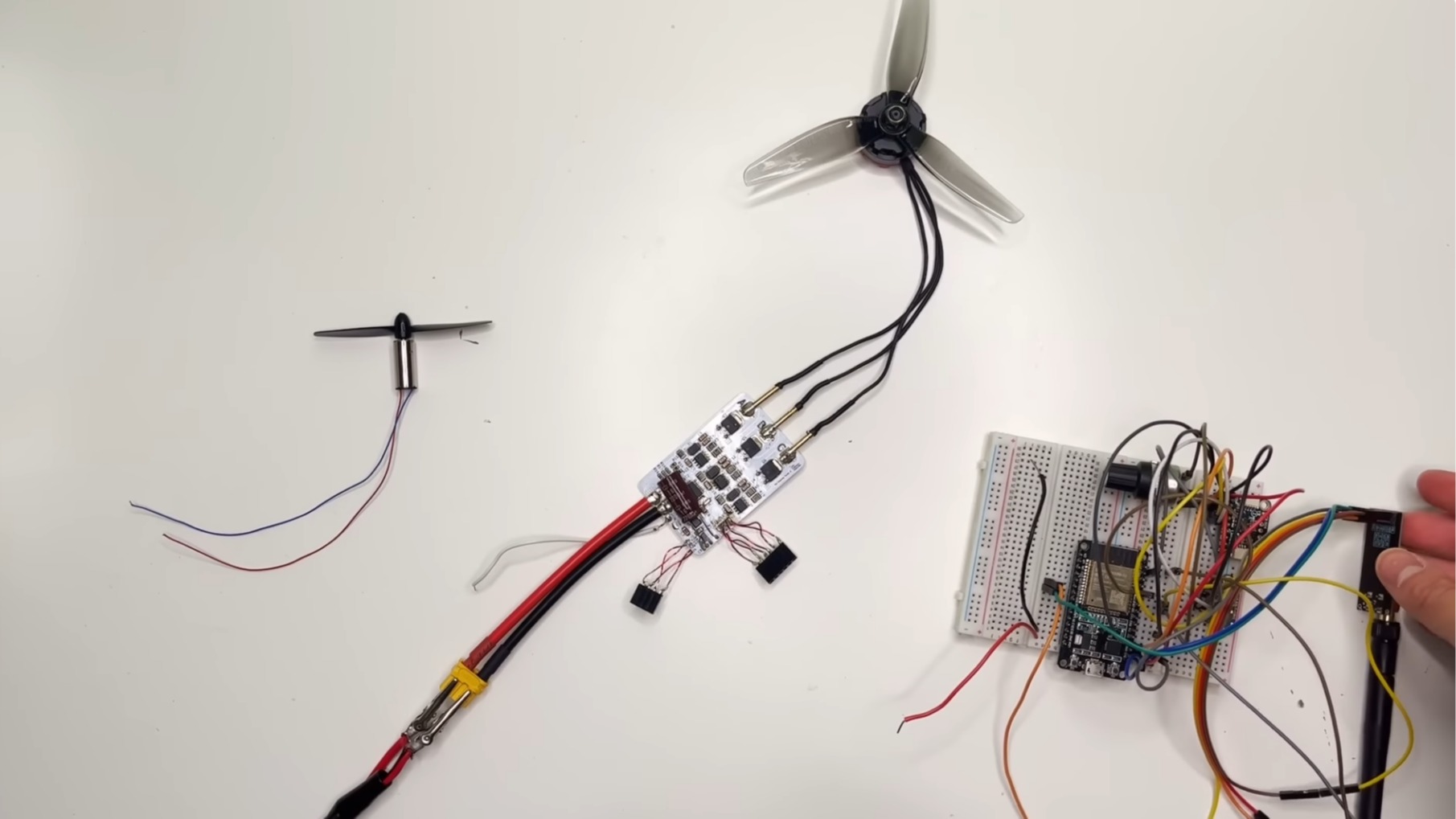 A photo of a brushed motor and brushless motor with a brushless controller board