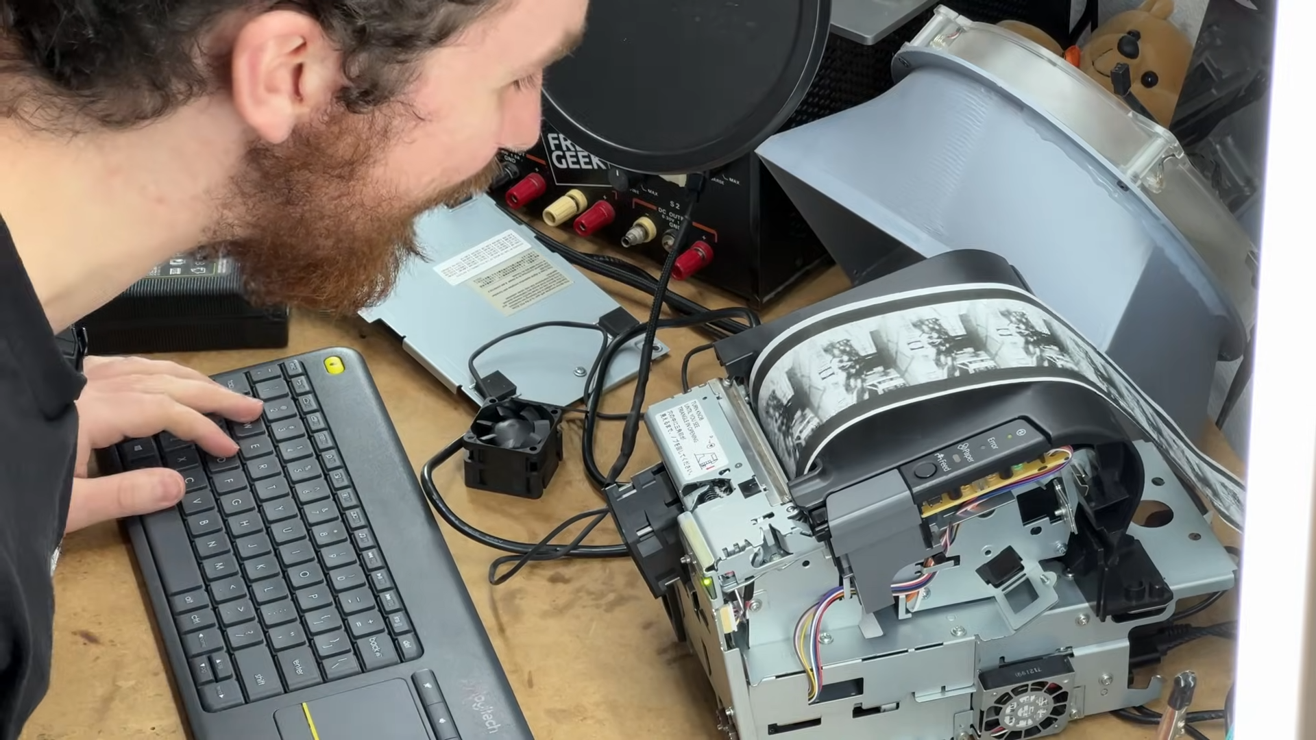 a torn-up printer with a very long image of different frames
