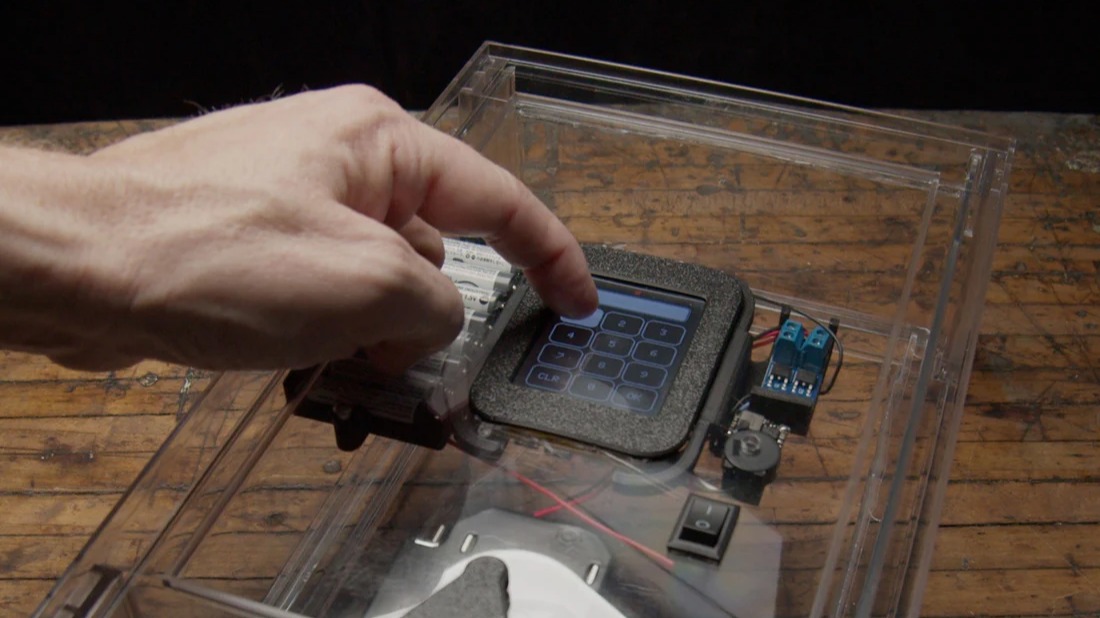 A hand operating a numeric touch pad