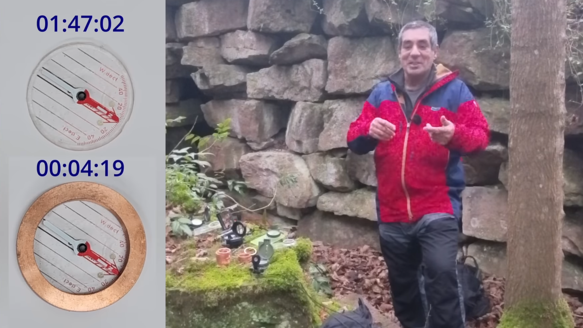 A man is shown standing in a wooded area, in front of a stone wall, facing toward the camera. To the left of him, on a rock, are a selection of compasses. Further to the left, another scene is shown, of two compasses. One has a brass-colored metal ring around it, and a timer above it reads 00:04:19. A timer above the other reads 01:47:02.