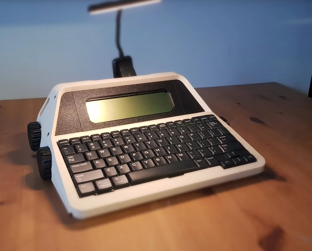 An AlphaSmart NEO in a 3D-printed, typewriter-esque enclosure, complete with big knobs.