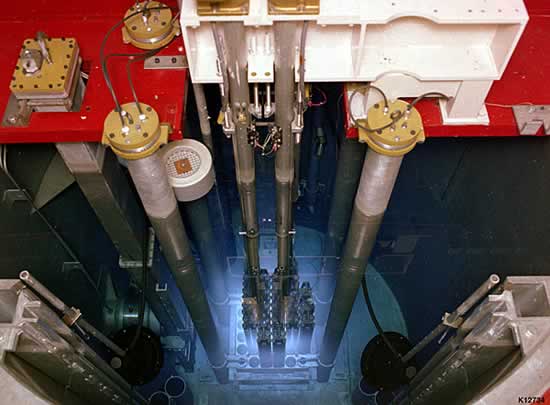A TRIGA reactor core, with the blue glow from Cherenkov radiation. (Source: DoE, Wikimedia)